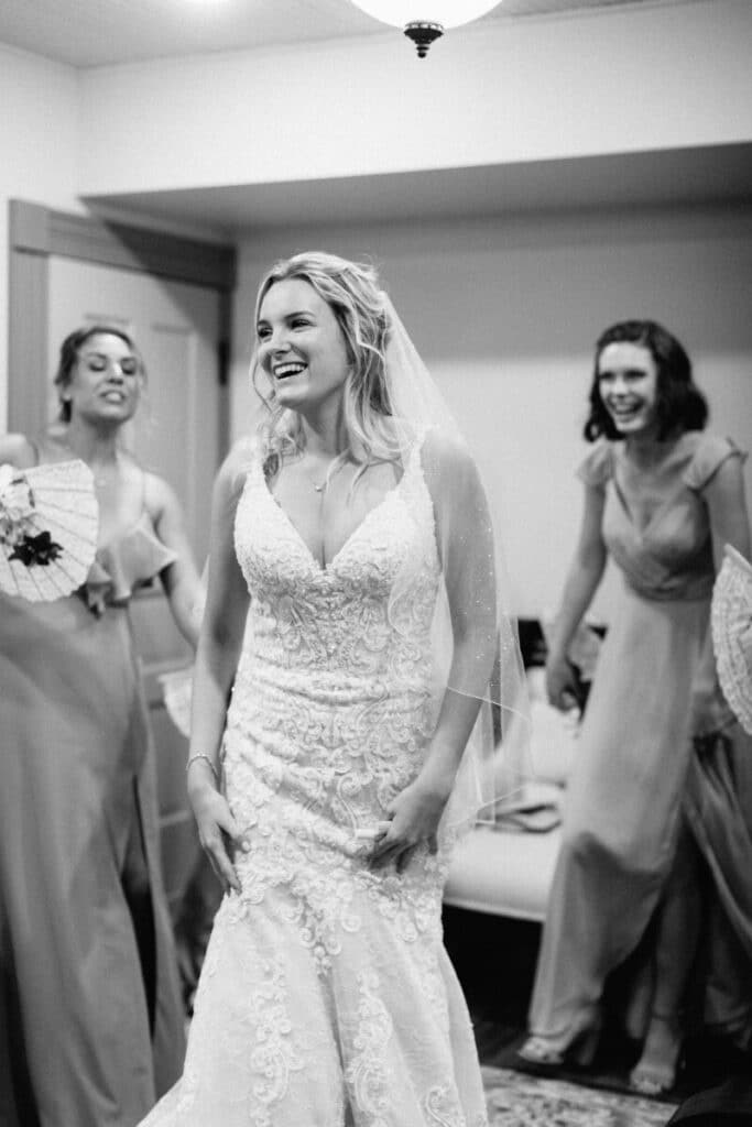 Bride laughing with her Bridesmaid and enjoying her wedding day.